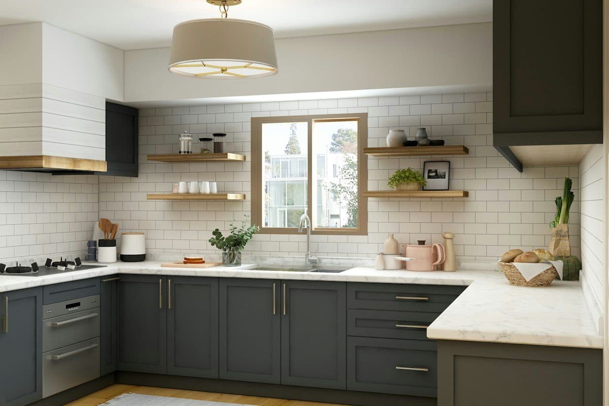 Small rental kitchen with a clean subway-tile-style peel-and-stick backsplash between white cabinets and a white countertop